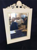 A small white wooden mirror