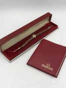 An Omega 9ct ladies watch in a red box with original papers