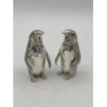 A Pair of 800 silver novelty condiments in the form of Penguins with glass eyes
