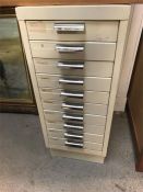 A slim metal filing cabinet