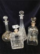 A collection of Four Decanters two with silver necks