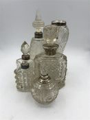 A selection of scent bottles with hallmarked silver necks