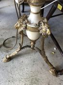 A marble and gilt metal standard lamp on three feet with ram detailing and marble table surround