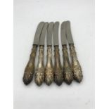 A set of six hallmarked silver handled butter knives