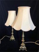 A pair of brass table lamps with Ivory shades