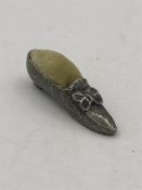 A Victorian pin cushion in the shape of a shoe