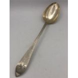 A hallmarked silver serving spoon, Dublin 1808. Total length 32cm, handle 22cm, bowl 10cm 110g.