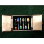 A boxed set of silver and enamel coffee spoons by Mappin & Webb