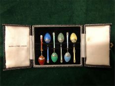 A boxed set of silver and enamel coffee spoons by Mappin & Webb