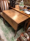 A Drop leaf table on castors with cutlery drawer