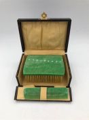 A Vintage Bakerlite brush and comb set in a box