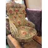 A Low button back nursing chair with a heavy fabric gold cover