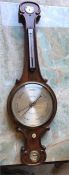 A mid Victorian Wheel Barometer with siphon tube by A J Marks of Sunderland with arch top and fitted