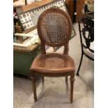 An Ornate French cane backed and seated chair