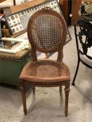 An Ornate French cane backed and seated chair