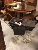 A Child's Silver Cross pram with matching bag 1950's plus a baby doll and bedding.
