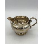 A silver milk jug, hallmarked London 1918