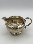 A silver milk jug, hallmarked London 1918