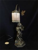 A Bronze effect Cherub themed table lamp.