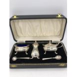 A hallmarked silver boxed cruet set