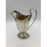A Victorian hallmarked silver milk jug, makers mark EB