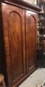 A Large mahogany wardrobe with drawer under