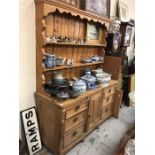 A Pine dresser with two shelves, six drawers, middle cupboard.