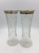 Two hallmarked silver topped glass vases.