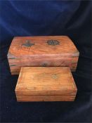 Two wooden boxes with brass inlay.