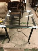 A Square wrought iron glass topped table