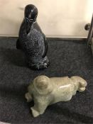 A stone seal and a wooden Penguin