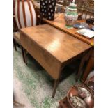 A Drop leaf table on castors with cutlery drawer