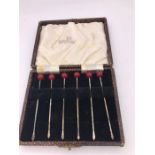 A Boxed set of Walker and Hall silver cocktail sticks