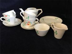 A dolls or children's china tea set for four with cups, saucers, teapot (missing lid), side