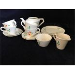 A dolls or children's china tea set for four with cups, saucers, teapot (missing lid), side