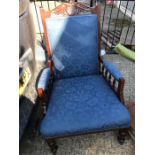An Edwardian chair on castors in blue fabric