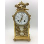 A French Eight Day Mantle clock with enamel face with flora decoration