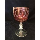 A glass Christening goblet with coin in the stem.