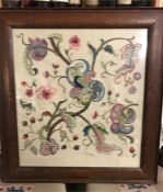 A framed needlework piece