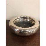 A white metal hammered bowl