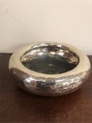 A white metal hammered bowl