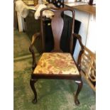 A single bedroom chair with floral seat.