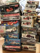 Twenty assorted model kits for various cars