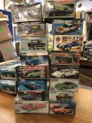 A selection of sixteen model kits for cars