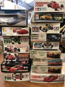 Sixteen model kits for cars from various makers