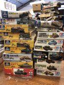 A selection of model kits of military vehicles and tanks, eighteen in total