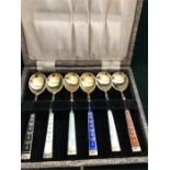 A boxed set of silver and enamel coffee spoons, made in Norway.