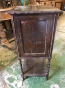 A pot cupboard with barley twist legs