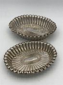 A Pair of Chinese white metal ornate dishes