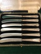 A boxed set of silver handled butter knives, one AF.